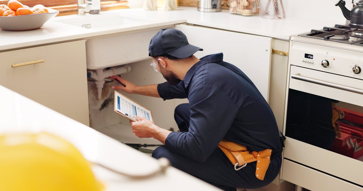 Plumber with clipboard ready to help customers